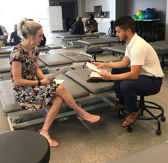 Two students in the lab with papers